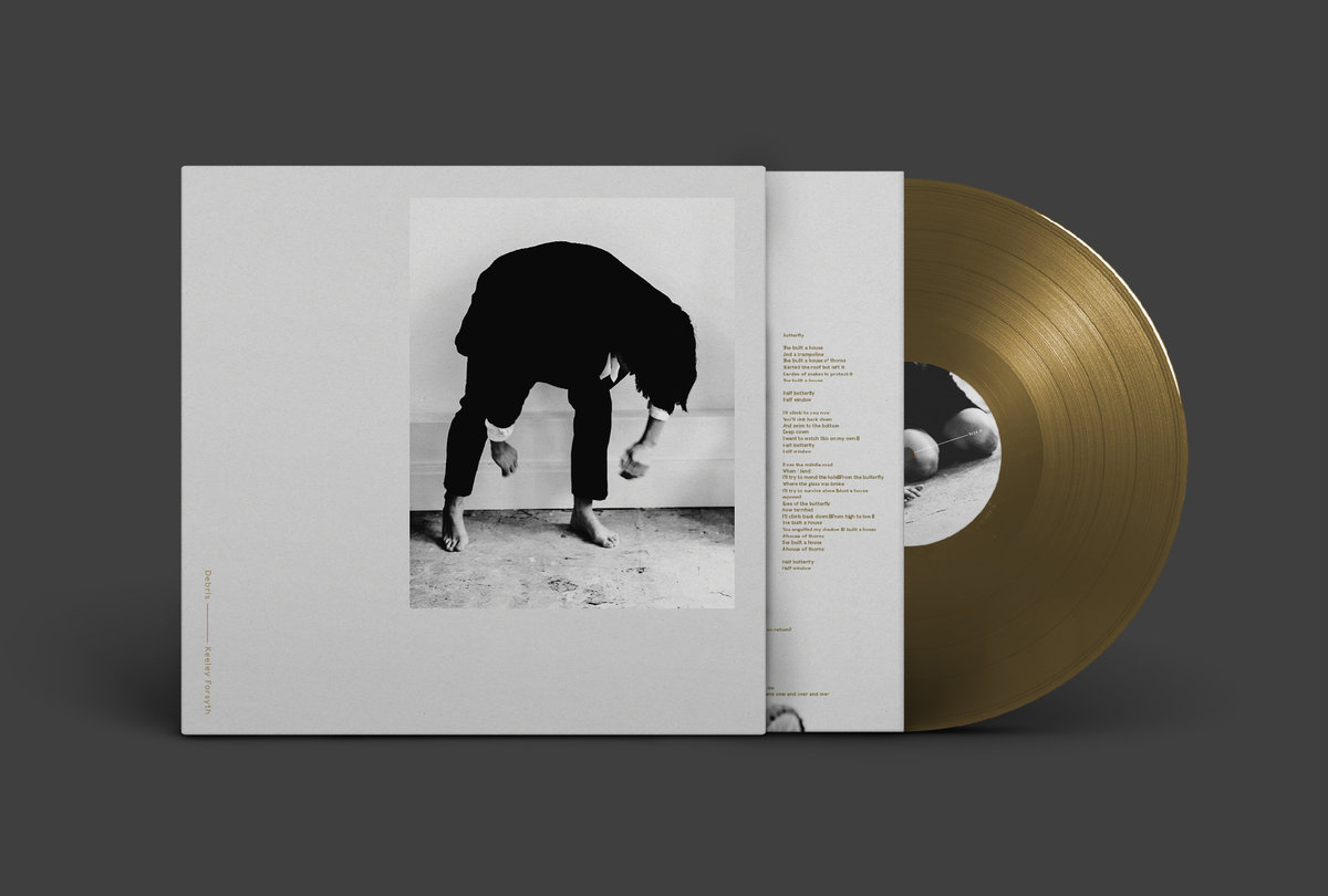 Debris cover art and gold vinyl LP.